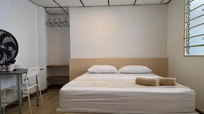 a bedroom with a bed with two pillows and a table at ABC-53 Housing in Medellín