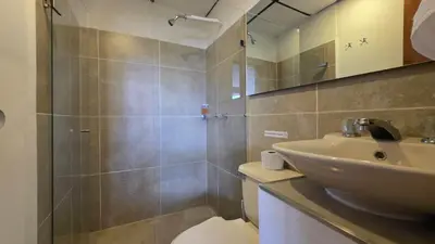 a bathroom with a sink and a toilet and a mirror at ABC-53 Housing in Medellín