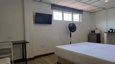 a room with a bed and a fan and a tv at ABC-53 Housing in Medellín