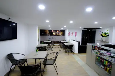 a restaurant with tables and chairs and a bar at Element Hotel in Medellín