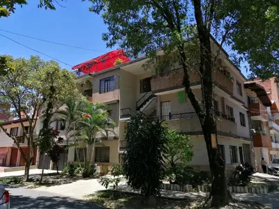 an apartment building with a red roof on a street at Selvática Alojamiento Eco in Medellín