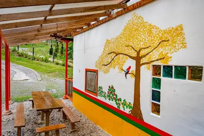 a mural of a tree on the side of a building at Kantarrana Casa de Campo in Jardin