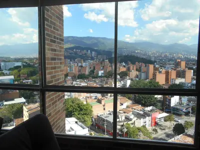 a view of a city from a window at Apartasuites AV in Medellín