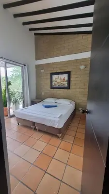 a bedroom with a bed in a room at San Jeronimo Cabaña in San Jerónimo
