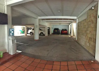 an empty parking garage with cars parked in it at Monteverde Hotel in La Dorada