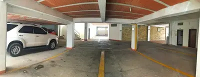 a white van parked in a parking garage at Monteverde Hotel in La Dorada