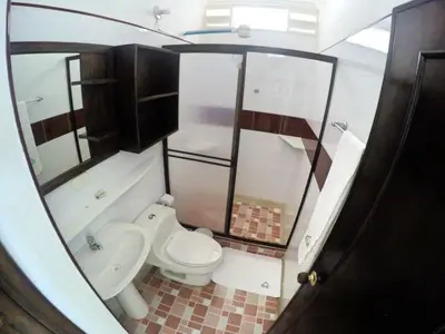 a small bathroom with a toilet and a sink at Monteverde Hotel in La Dorada