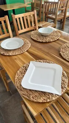 a wooden table with a white plate on top of it at Monteverde Hotel in La Dorada