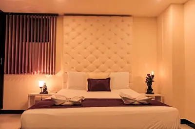 a bedroom with a large white bed and a window at Hotel Plaza Garibaldi in Caldas