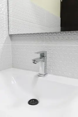 a sink in a bathroom with a faucet at Hotel Plaza Garibaldi in Caldas