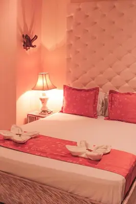 a bedroom with a bed with two towels on it at Hotel Plaza Garibaldi in Caldas