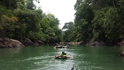 a group of people in the water in a river at Cabaña Familiar La Aldea Doradal in Gesen