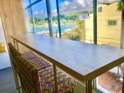 a table in a room with a view of the water at Aptos vista al Embalse, frente al lago, Restaurantes, Bares in Guatapé