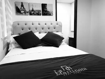 a black and white bedroom with a large bed at Aptos vista al Embalse, frente al lago, Restaurantes, Bares in Guatapé