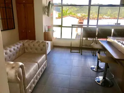 a living room with a couch and a table at Aptos vista al Embalse, frente al lago, Restaurantes, Bares in Guatapé