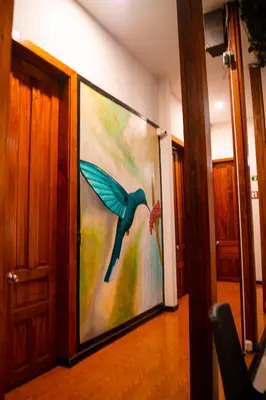 a painting of a blue bird on a wall at Casabella Hotel in Manizales