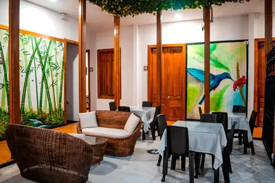 a restaurant with tables and chairs and a painting on the wall at Casabella Hotel in Manizales