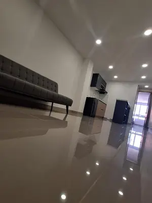 a living room with a couch in a room at Hotel Granada Plaza in Manizales