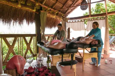 a couple of people laying on a bed in a room at Hosteria Tonusco Campestre in Santa Fe de Antioquia