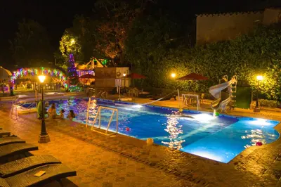 a swimming pool at night with a person jumping into it at Hosteria Tonusco Campestre in Santa Fe de Antioquia