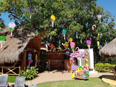 a house with a tree with lots of signs at Hosteria Tonusco Campestre in Santa Fe de Antioquia