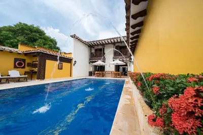 a house with a swimming pool in a yard at Nueva Granada Hotel Colonial -Centro Histórico- in Santa Fe de Antioquia