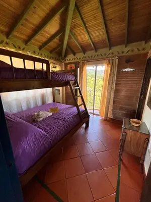 a bedroom with two bunk beds in a house at Casa Encuentro Ecolodge, Outdoor Gym and Yoga in Guatapé