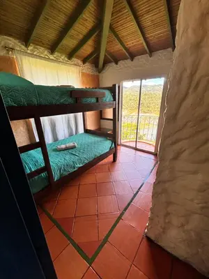 a room with two bunk beds and a window at Casa Encuentro Ecolodge, Outdoor Gym and Yoga in Guatapé