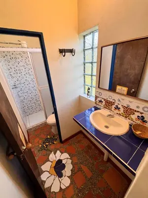 a bathroom with a sink and a mirror at Casa Encuentro Ecolodge, Outdoor Gym and Yoga in Guatapé