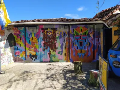 a building with a painting on the side of it at Casa Encuentro Ecolodge, Outdoor Gym and Yoga in Guatapé