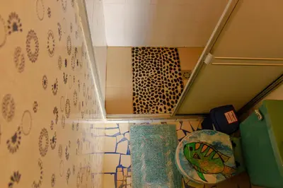 a bathroom with a shower with a mirror and a toilet at Casa Encuentro Ecolodge, Outdoor Gym and Yoga in Guatapé