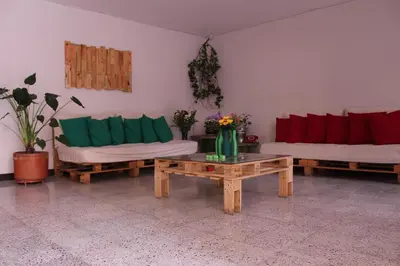 a living room with two couches and a coffee table at Hostal Paz y Vida in Medellín