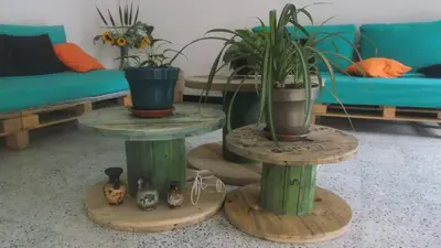a living room with two tables with potted plants on them at Hostal Paz y Vida in Medellín