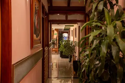 a hallway with potted plants in a building at Hotel Santamaria INN in La Ceja