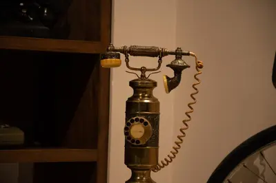 an antique phone is attached to a wall at Hotel Santamaria INN in La Ceja
