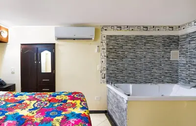 a bedroom with a bed and a brick wall at Apartamentos en el Poblado in Medellín