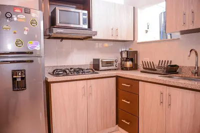 a kitchen with a stainless steel refrigerator and a microwave at Manilla House in Medellín