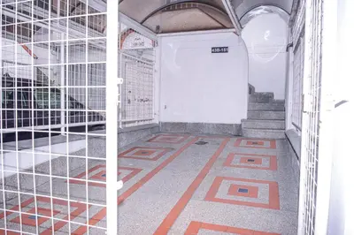 two images of an empty room with a stairway at Manilla House in Medellín