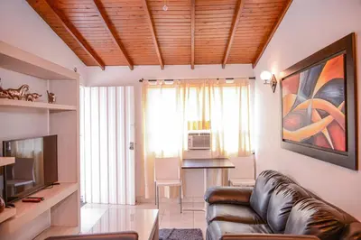 a living room with a couch and a table at Manilla House in Medellín