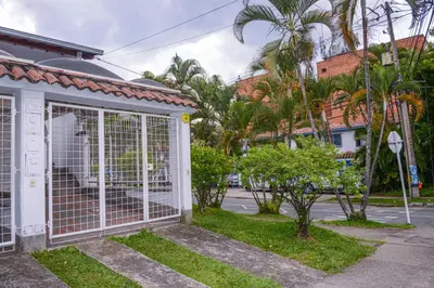 a white gate in the front of a house at Manilla House in Medellín