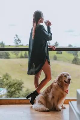 a woman is taking a picture of a dog at Travelers Rio Verde Living Suites in Rionegro