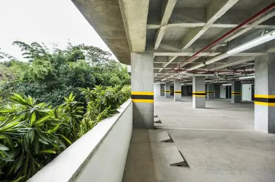 an empty parking garage with yellow and black stripes at Travelers Rio Verde Living Suites in Rionegro