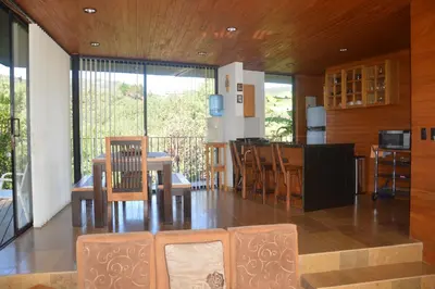 a kitchen and dining room with a table and chairs at Cabañas el Retorno in Guatapé