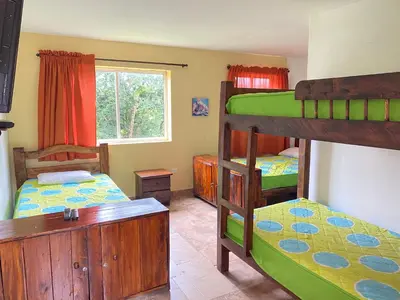a bedroom with two bunk beds and a window at Finca Hotel La Ponderosa in Rionegro