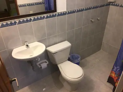 a bathroom with a toilet and a sink at Finca Hotel La Ponderosa in Rionegro