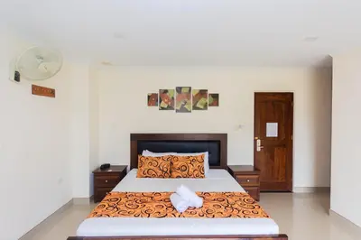 a bedroom with a large bed in a room at Hotel Verony Guatape in Guatapé