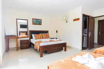 a bedroom with a bed and a mirror in it at Hotel Verony Guatape in Guatapé