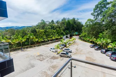 a parking lot with cars parked in a parking lot at Hotel Verony Guatape in Guatapé