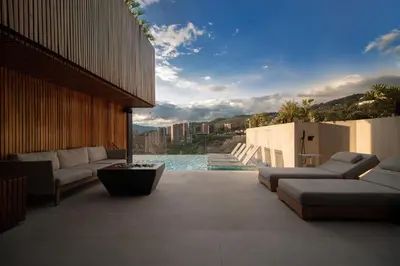 a patio with couches and a view of the water at Binn Hotel in Medellín