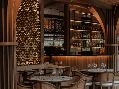 a restaurant with tables and chairs and a bar at Binn Hotel in Medellín